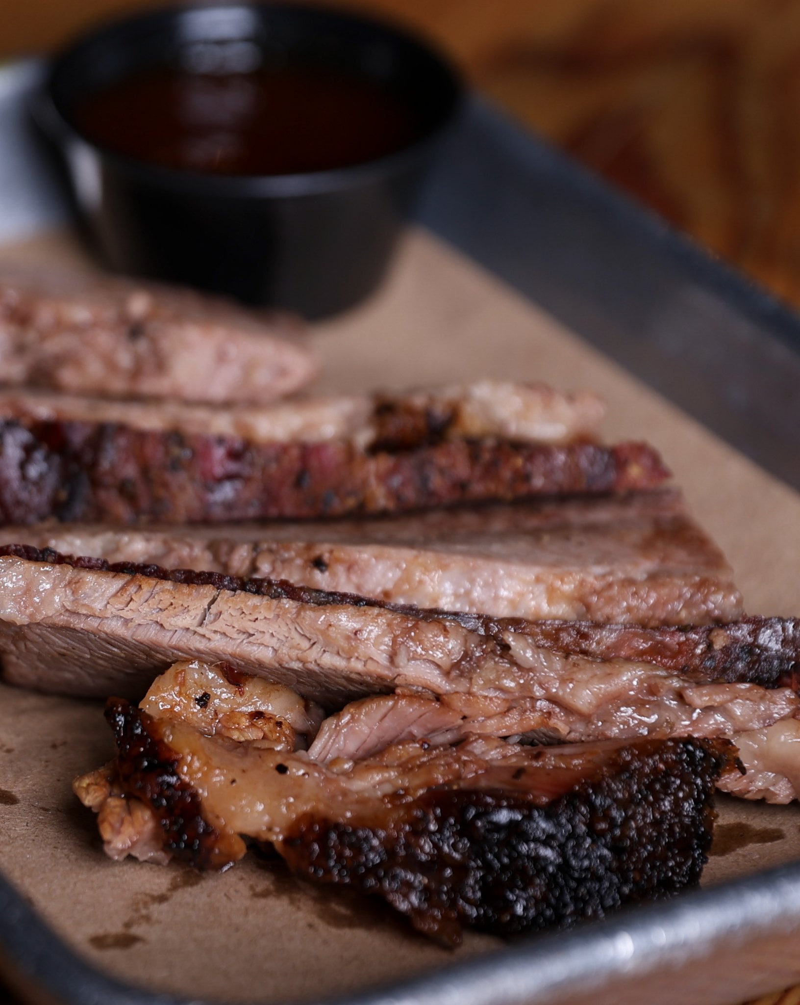 Hand-cut slow-smoked brisket sliced on butcher paper