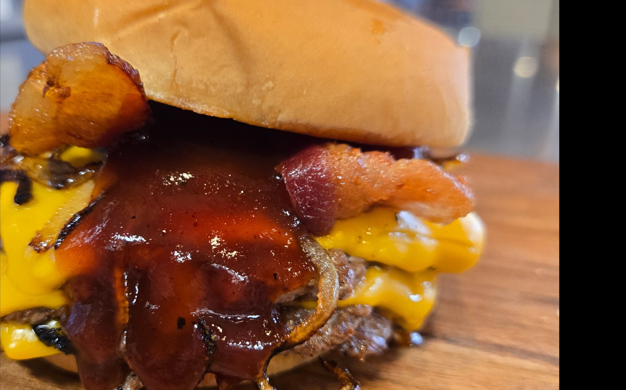 BBQ Bomb burger with bacon, grilled onions and signature BBQ sauce