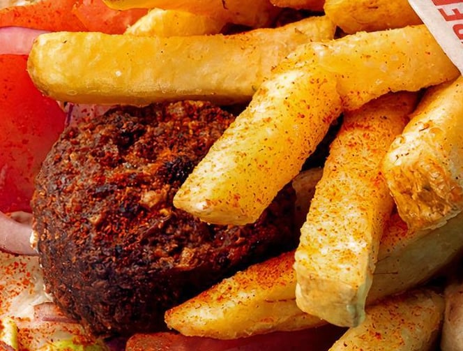 Crispy falafel pita with fresh vegetables and creamy sauce