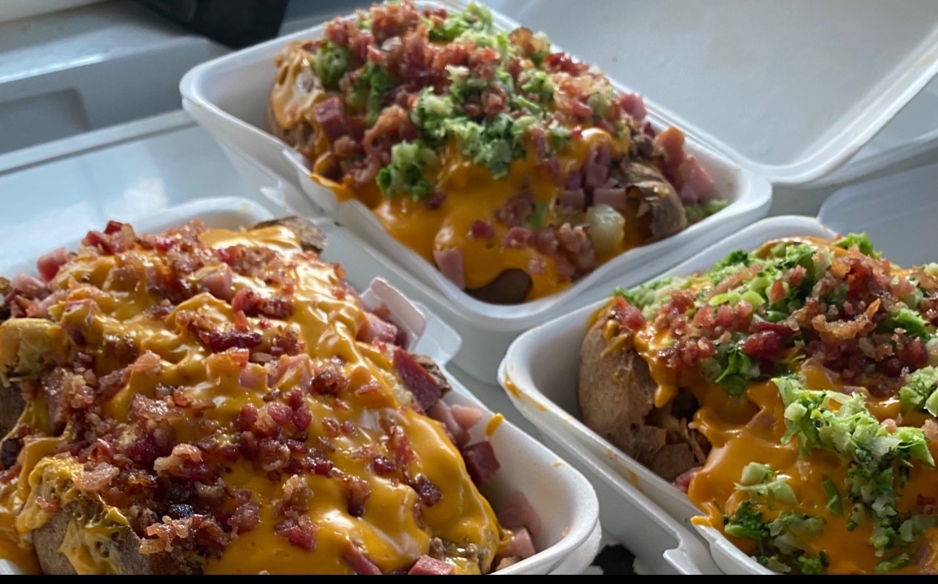 Batatasita loaded baked potato with mixed meats, bacon and cheddar served with nachos