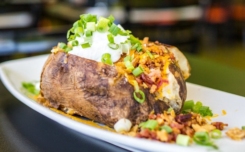 Loaded stuffed spud topped with cheese, bacon bits and sour cream