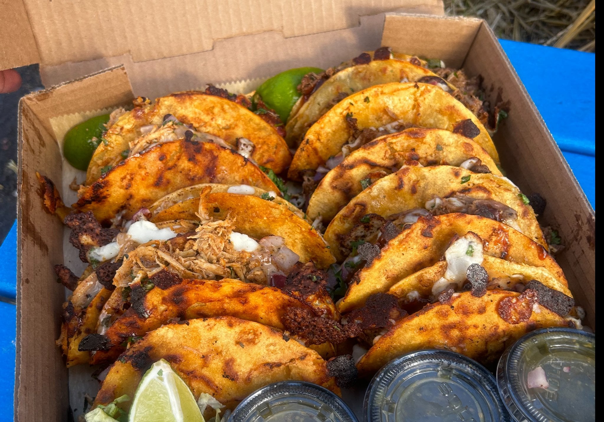 Taco sampler box with five tacos and Mexican corn