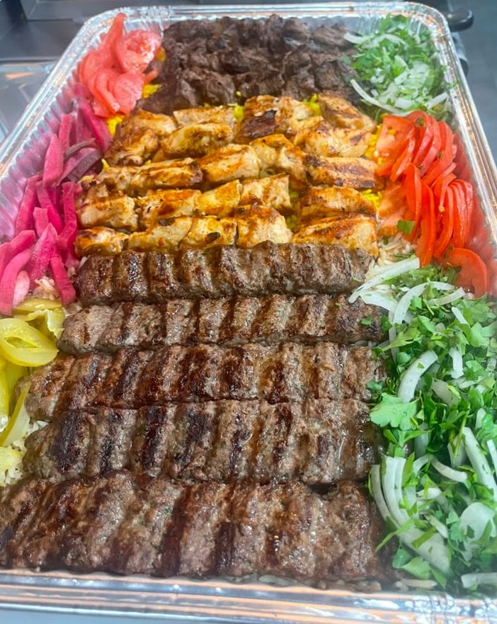 Mixed grill platter with skewered chicken, beef kebabs, and lamb