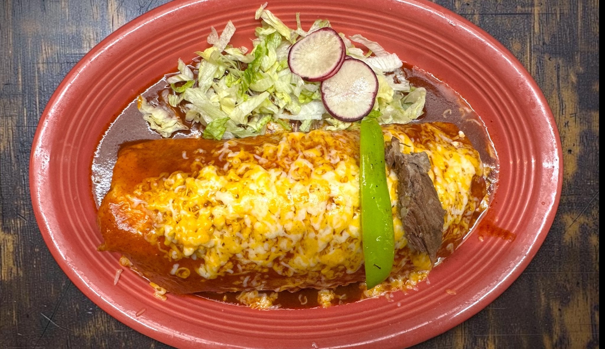 Mega Wet Burrito smothered in enchilada sauce and melted cheese