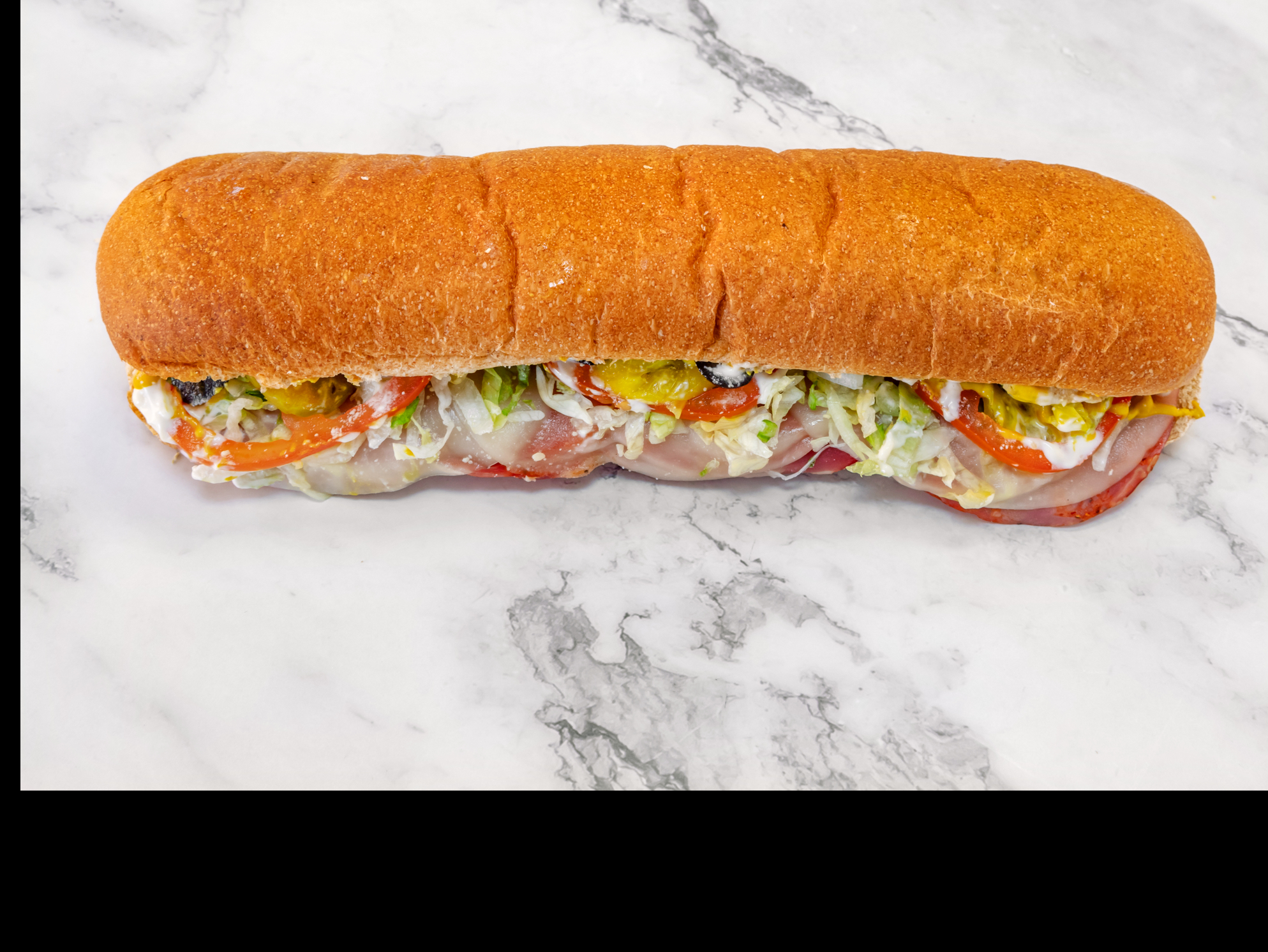 Classic Italian sub loaded with salami, capocollo, and pepperoni on fresh bread