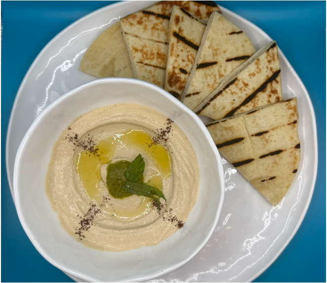 Mediterranean dishes from The Pita arranged for a vibrant coastal-style meal