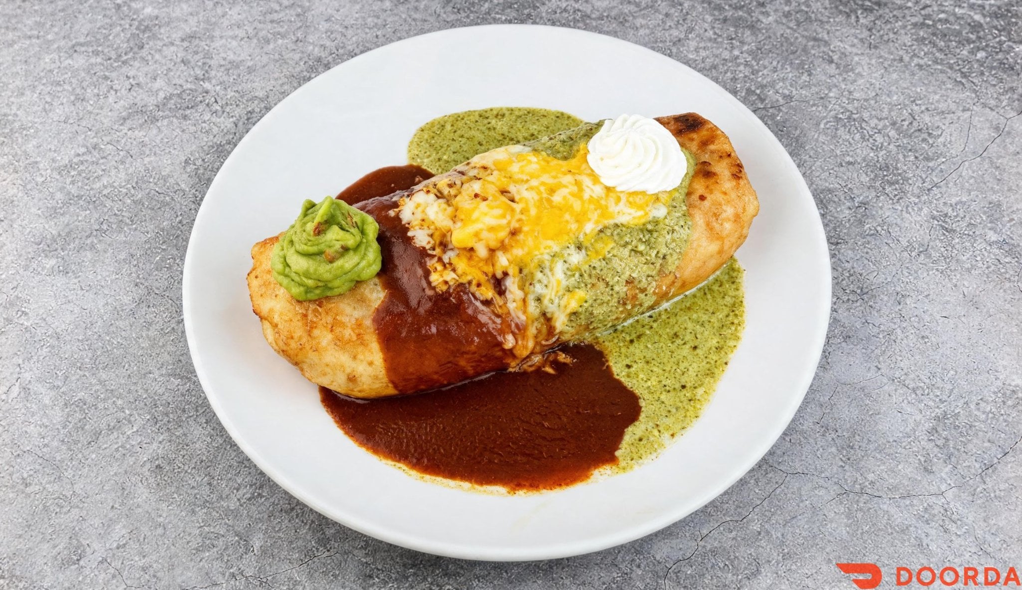 Chimichanga deep fried and covered with enchilada sauce and melted cheese