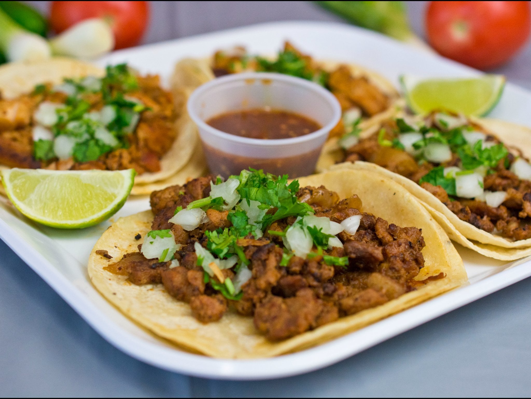 Bowl of pozole served with tortillas on the side
