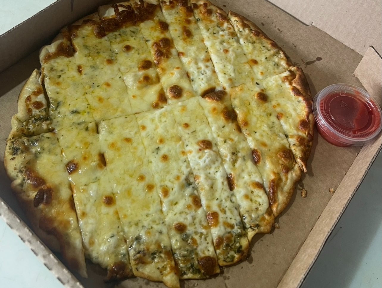 Golden garlic cheese sticks with pizza sauce for dipping