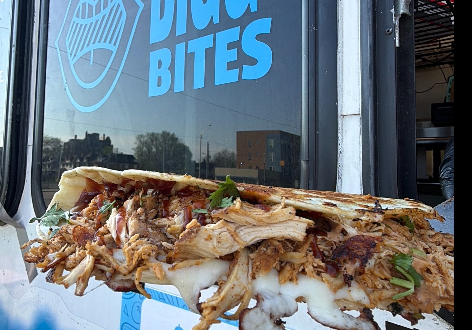 Large quesadilla cut into four triangles with sides of lettuce and salsa