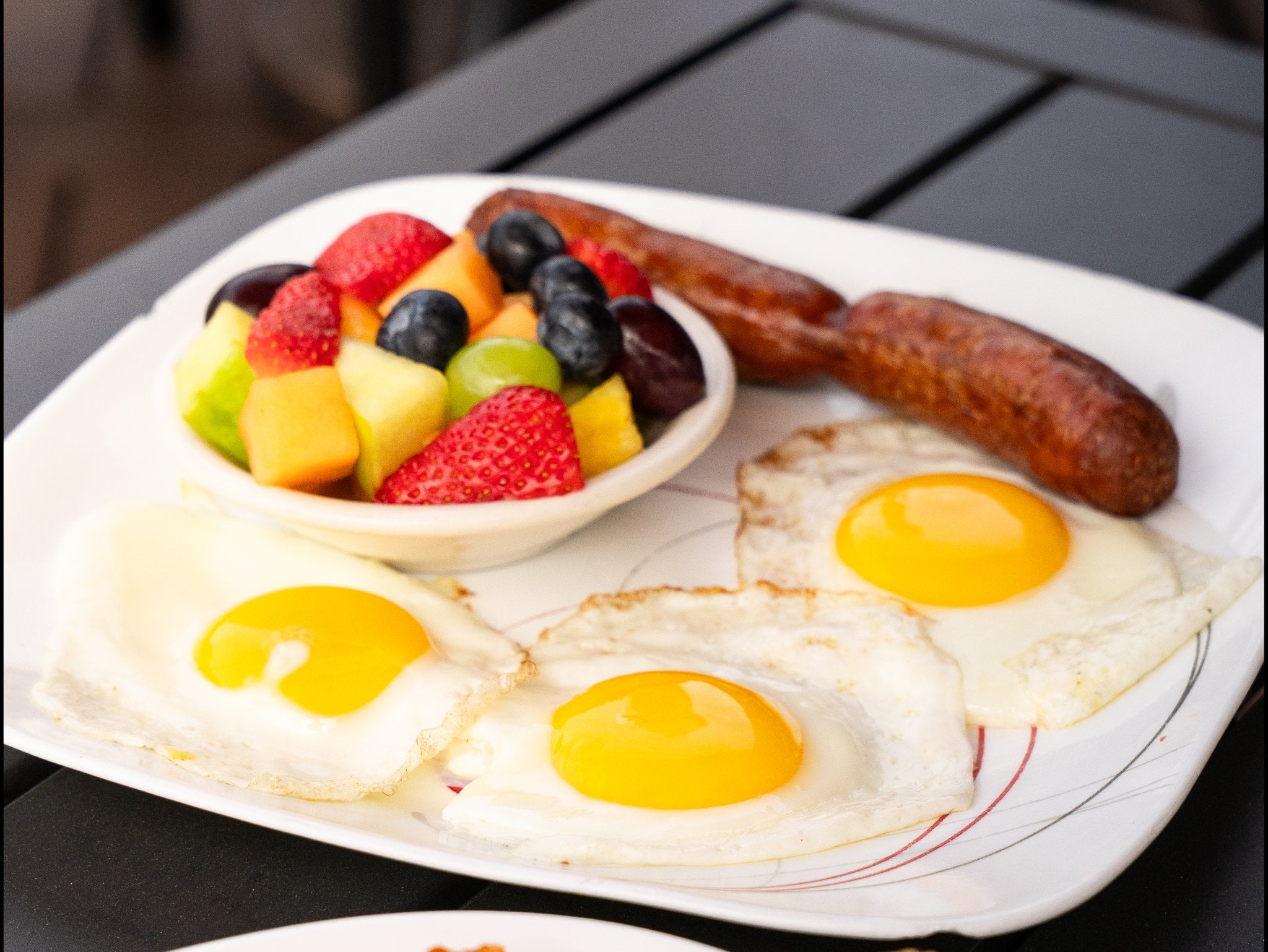 Two large farm eggs with meat, home fries and toast