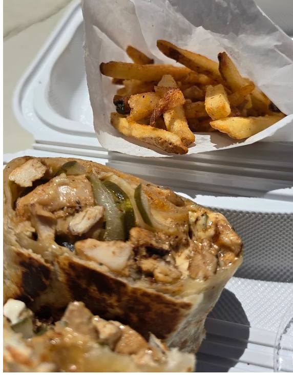 Fresh Mediterranean meal from The Pita with colorful ingredients and warm pita