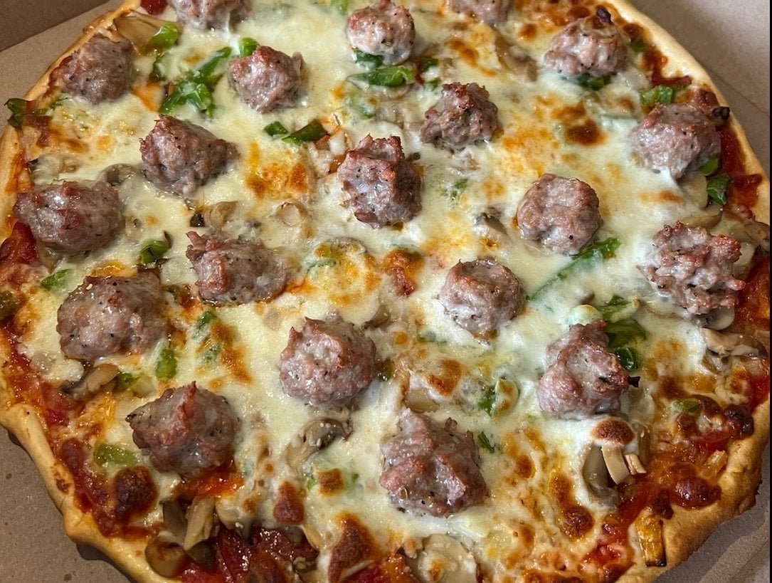 Deluxe pizza with sausage, pepperoni, mushrooms, onions and green peppers