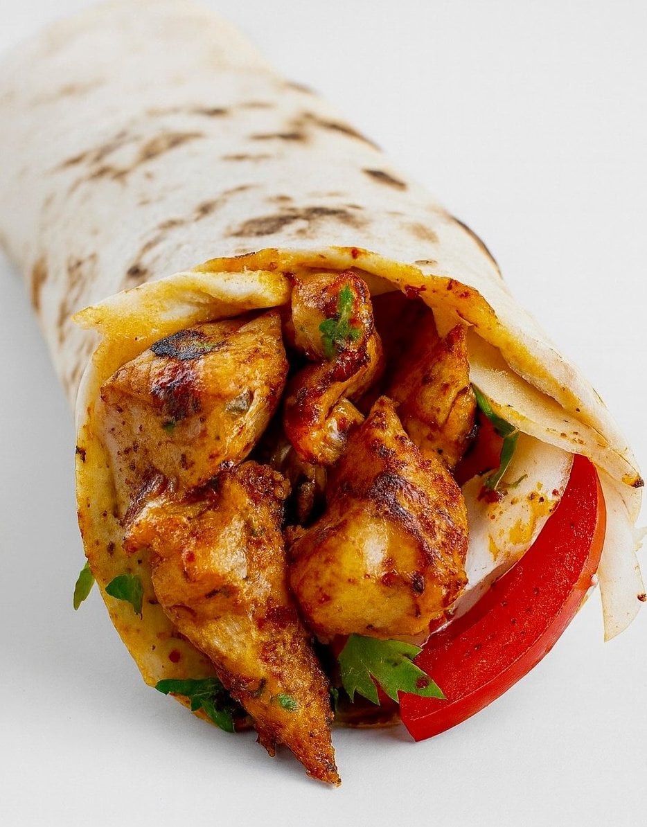Fresh Mediterranean meal from The Pita with colorful ingredients and warm pita