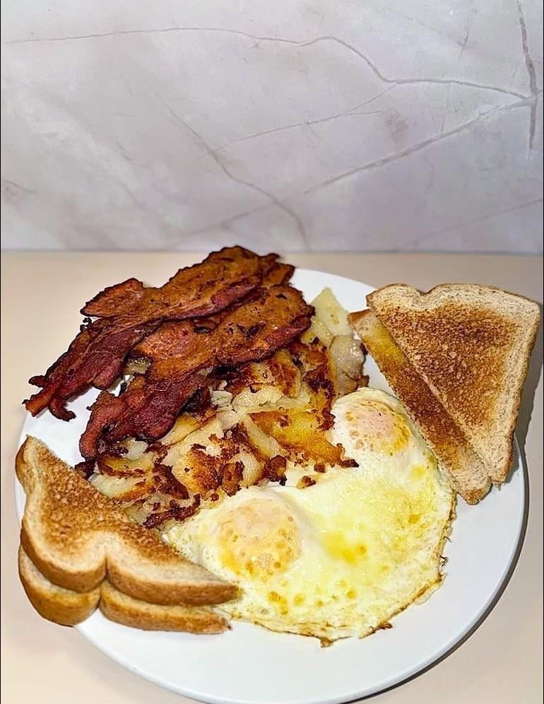 Classic breakfast of eggs, bacon, home fries and toast at Spiros