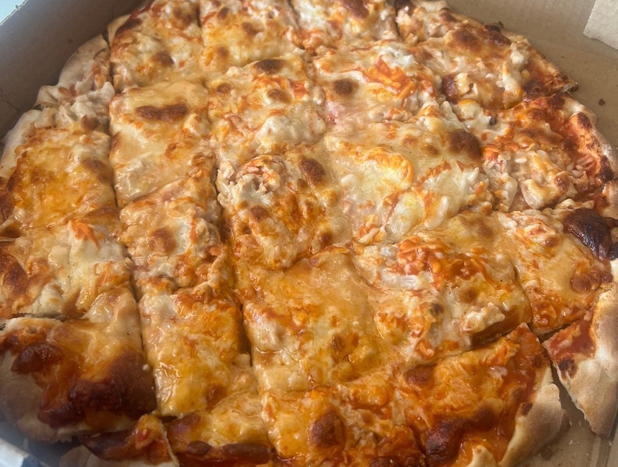 Buffalo chicken pizza topped with chicken and ranch