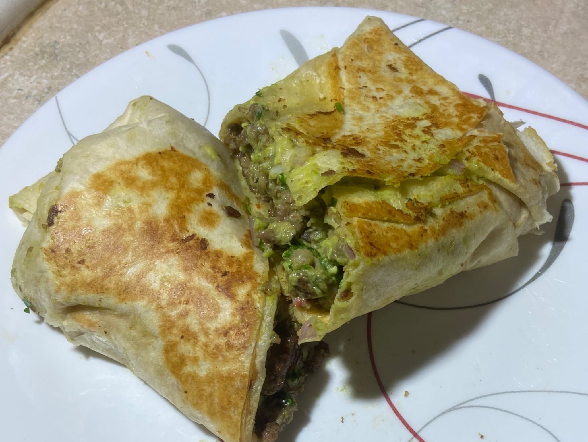Hearty burrito stuffed with beans, cheese, meat and guacamole
