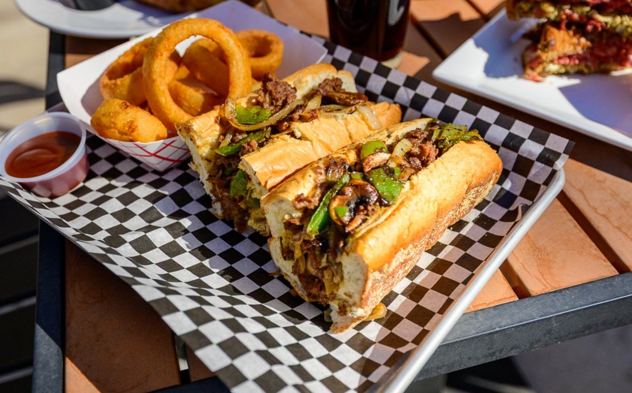 The Works cheesesteak loaded with peppers, onions, and mushrooms