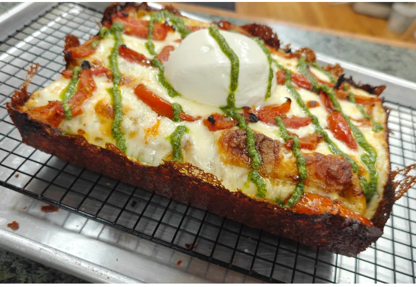 Burrata Bomb pizza with roasted tomatoes, burrata and pesto drizzle