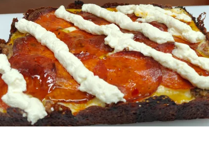 The Resolution Breaker pizza with cream cheese, pepperoni and ricotta stripes